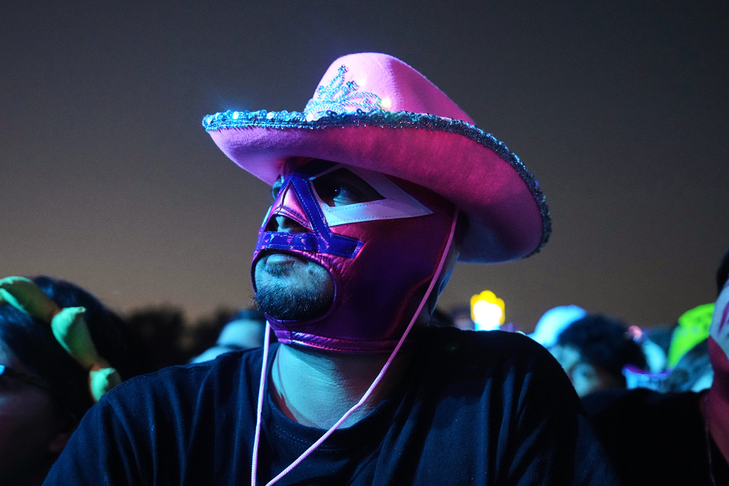 A fan watches the Scottish band Mogwai during the Corona Capital music festival in Mexico City, Saturday, Nov. 15, 2025. (AP Photo/Claudia Rosel)