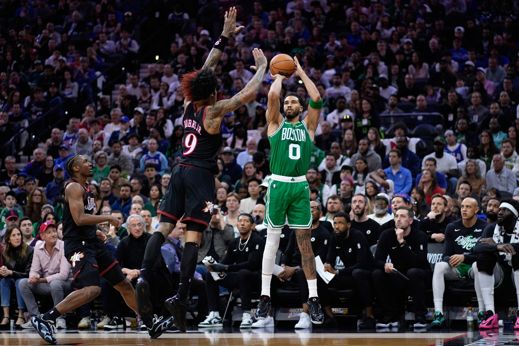 Boston Celtics' Jayson Tatum (0) goes up for a shot against Philadelphia 76ers' Kelly Oubre Jr. (9) during the first half of Game 4 in a first-round NBA basketball playoffs series Sunday, April 26, 2026, in Philadelphia. (AP Photo/Matt Slocum)