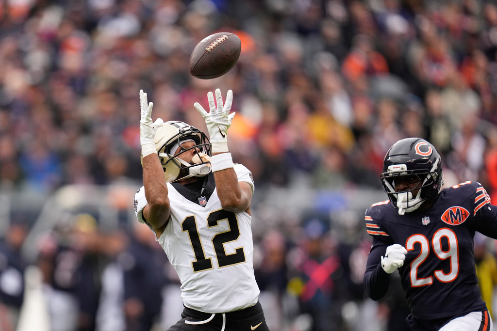 New Orleans Saints wide receiver Chris Olave (12) pulls in a long pass play past Chicago Bears cornerback Tyrique Stevenson (29) in the first half of an NFL football game, Sunday, Oct. 19, 2025, in Chicago. (AP Photo/Erin Hooley)