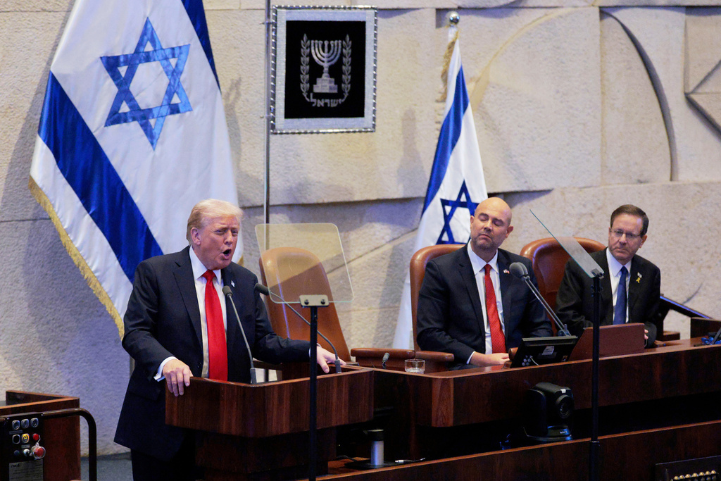 President Donald Trump addresses the Knesset, Israel's parliament, next to Amir Ohana, Speaker of the Israeli Knesset, and Israeli President Isaac Herzog, Monday, Oct. 13, 2025, in Jerusalem. (Chip Somodevilla/Pool via AP)