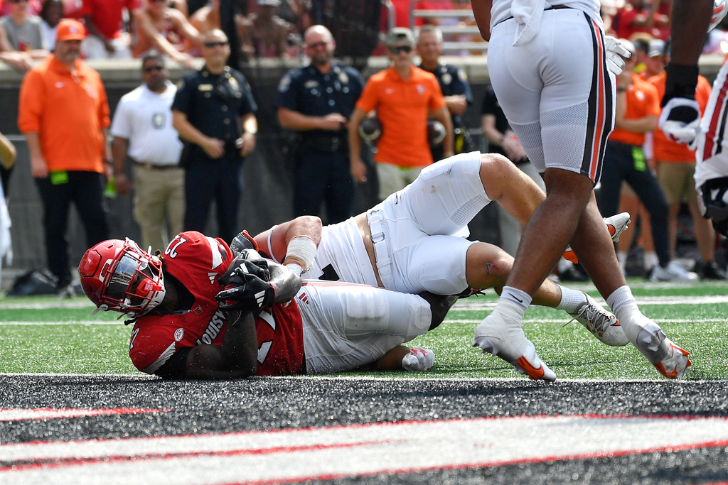 Louisville running back Keyjuan Brown (22) is tackled as he crosses the goal line to score during the first half of an NCAA college football game against Bowling Green in Louisville, Ky., Saturday, Sept. 20, 2025. (AP Photo/Timothy D. Easley)