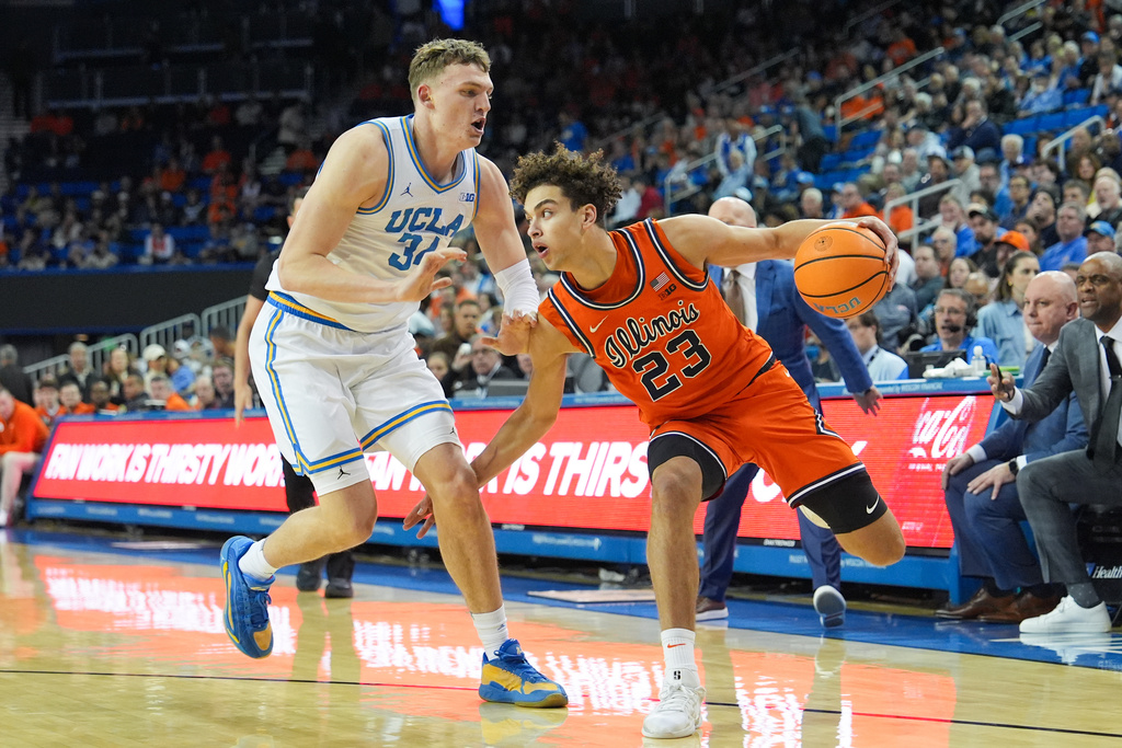 UCLA forward Tyler Bilodeau (34) pressures Illinois guard Keaton Wagler (23) during the first half of an NCAA college basketball game in Los Angeles, Saturday, Feb. 21, 2026. (AP Photo/Jae C. Hong)