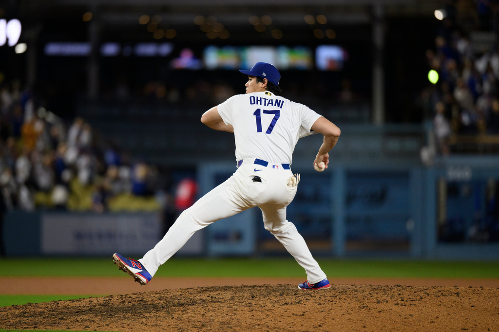 Los Angeles Dodgers' Shohei Ohtani pretends to pitch after a baseball game against the San Diego Padres in Los Angeles, Thursday, July 2, 2026. (AP Photo/Kyusung Gong)