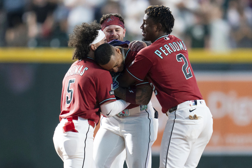 Arizona Diamondbacks teammates celebrate second baseman Ketel Marte's game-winning home run in the 10th inning of a baseball game against the Atlanta Braves, Sunday, April 5, 2026, in Phoenix. (AP Photo/Rebecca Noble)