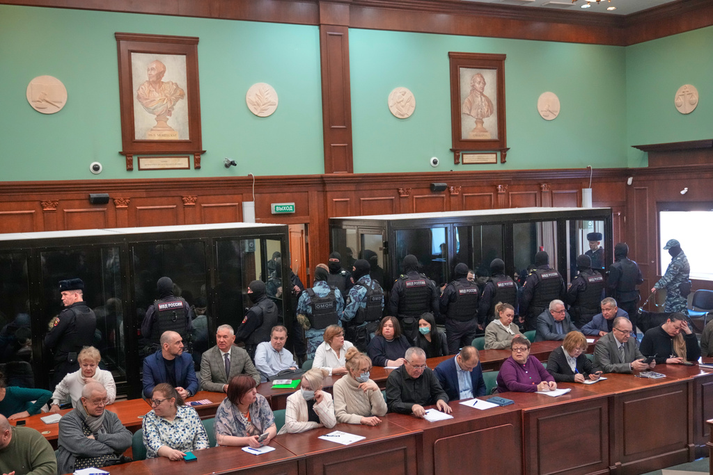 Men tried on the charges of involvement in a terror attack at the Crocus City Hall in March 2024 listen to the verdict in a glass cage at the Second Western District Military Court in Moscow, Russia, Thursday, March 12, 2026. (AP Photo/Pavel Bednyakov)