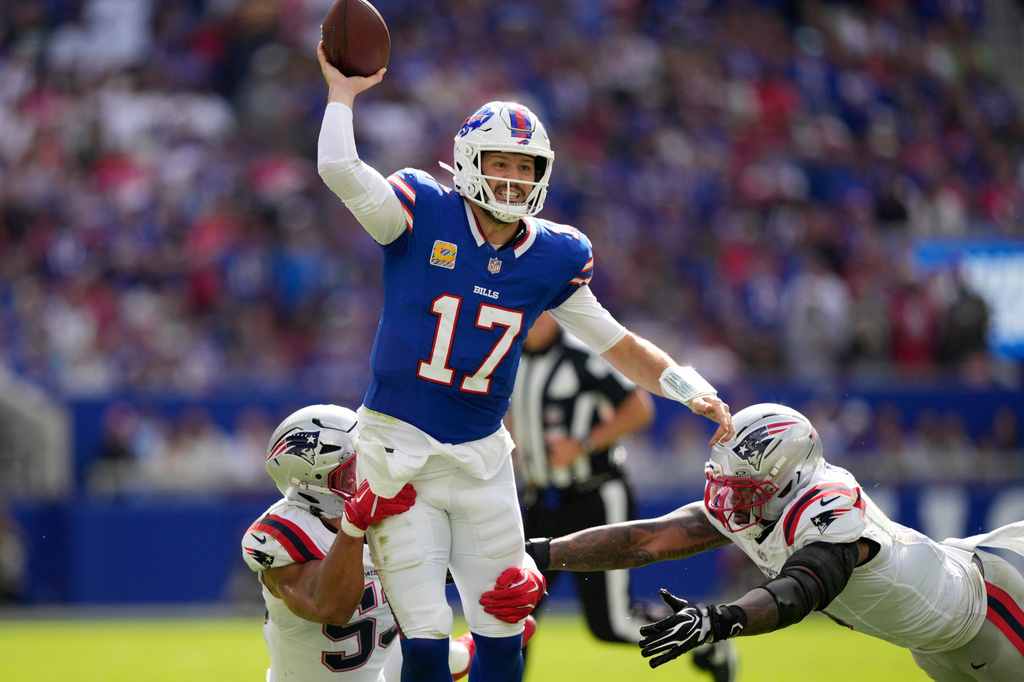 Buffalo Bills quarterback Josh Allen (17) passes against New England Patriots center Jared Wilson (55) and defensive end Dre'mont Jones (5) during an NFL football game in Orchard Park, N.Y., Sunday, Oct. 4, 2026. (AP Photo/Carolyn Kaster)