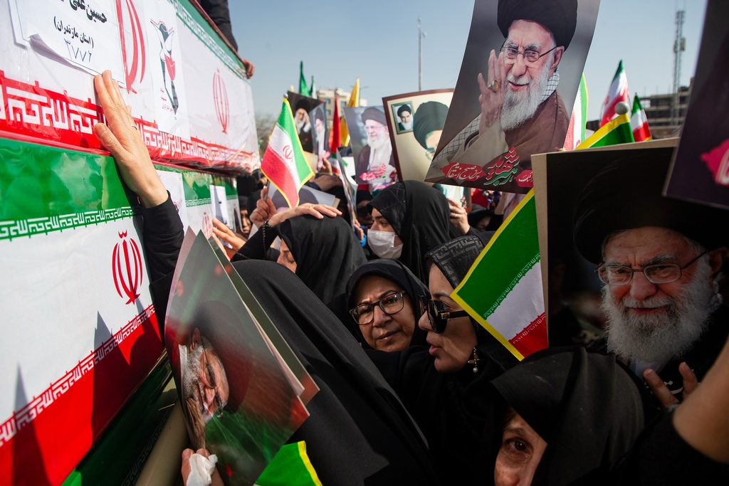 Some holding pictures of the late Iranian Supreme Leader Ayatollah Ali Khamenei, mourners reach out to coffins during a funeral for people killed during the ongoing U.S.–Israeli military campaign in Isfahan, Iran, Thursday, March 5, 2026. (Payman Shahsanaei/ISNA via AP)