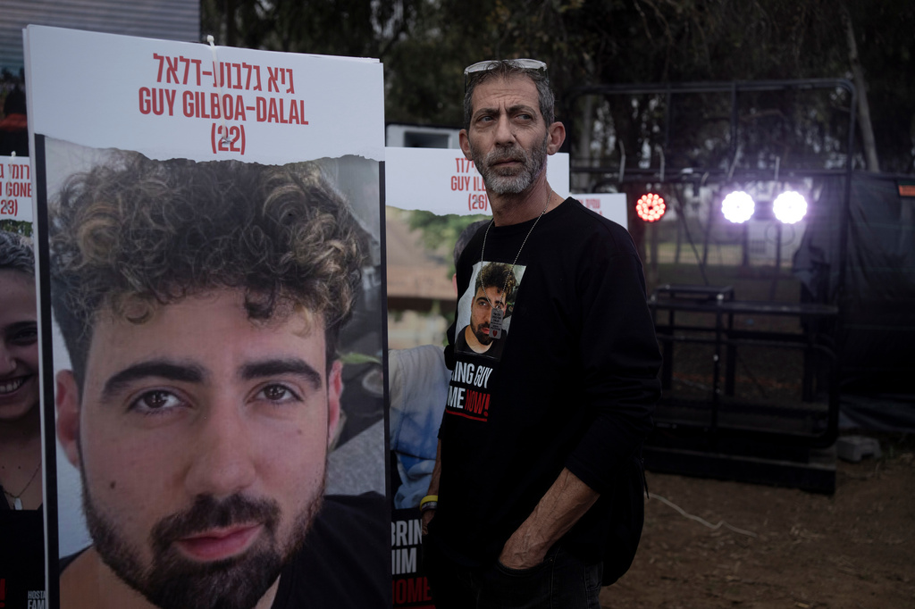FILE - Ilan Dalal, father of Guy Gilboa-Dalal, who was kidnapped on Oct. 7 in a cross-border attack by Hamas at the Nova music festival, stands next to a photo of his son during a press conference at the site in Re'im, southern Israel, Friday, Jan. 5, 2024. (AP Photo/Maya Alleruzzo, File)