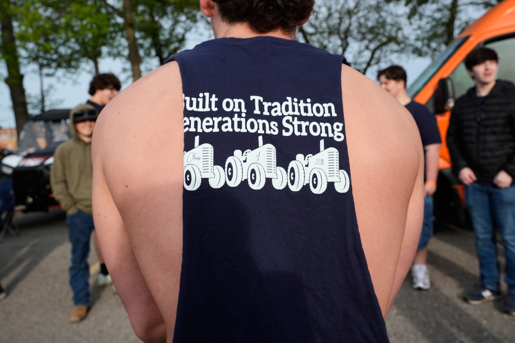 A senior wears a class shirt during Tractor Day for graduating seniors at Airport High School Friday, May 22, 2026, in Carleton, Mich. (AP Photo/Paul Sancya)