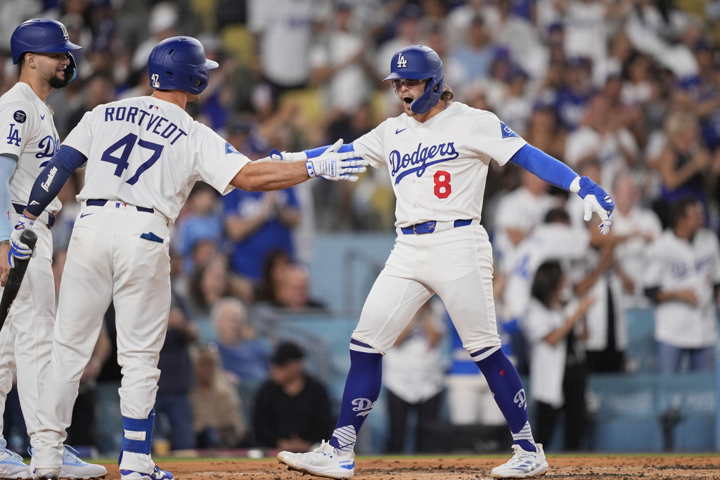 Los Angeles Dodgers' Kiké Hernandez (8) celebrates with teammates Ben Rortvedt (47) and Andy Pages after hitting a two-run home run during the second inning of a baseball game against the Philadelphia Phillies Tuesday, Sept. 16, 2025, in Los Angeles. (AP Photo/Mark J. Terrill)
