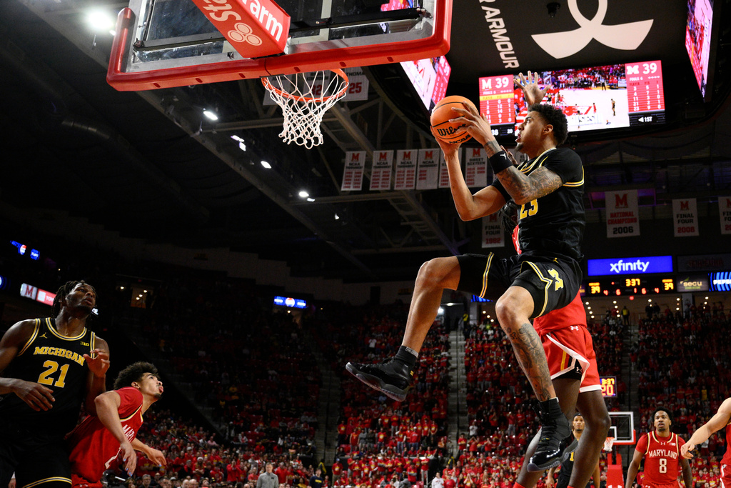 Michigan forward Yaxel Lendeborg (23) goes to the basket during the first half of an NCAA college basketball game against Maryland, Saturday, Dec. 13, 2025, in College Park, Md. (AP Photo/Nick Wass)