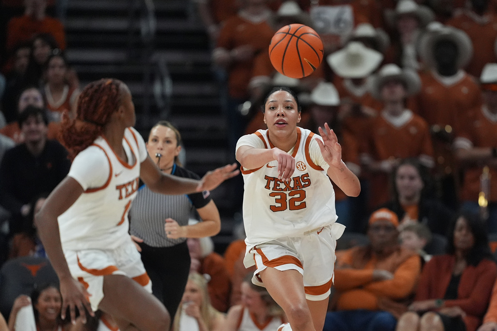 Texas forward Teya Sidberry (32) passes to guard Bryanna Preston (1) during the second half of an NCAA college basketball game against Texas A&M in Austin, Texas, Sunday, Jan. 18, 2026. (AP Photo/Eric Gay)