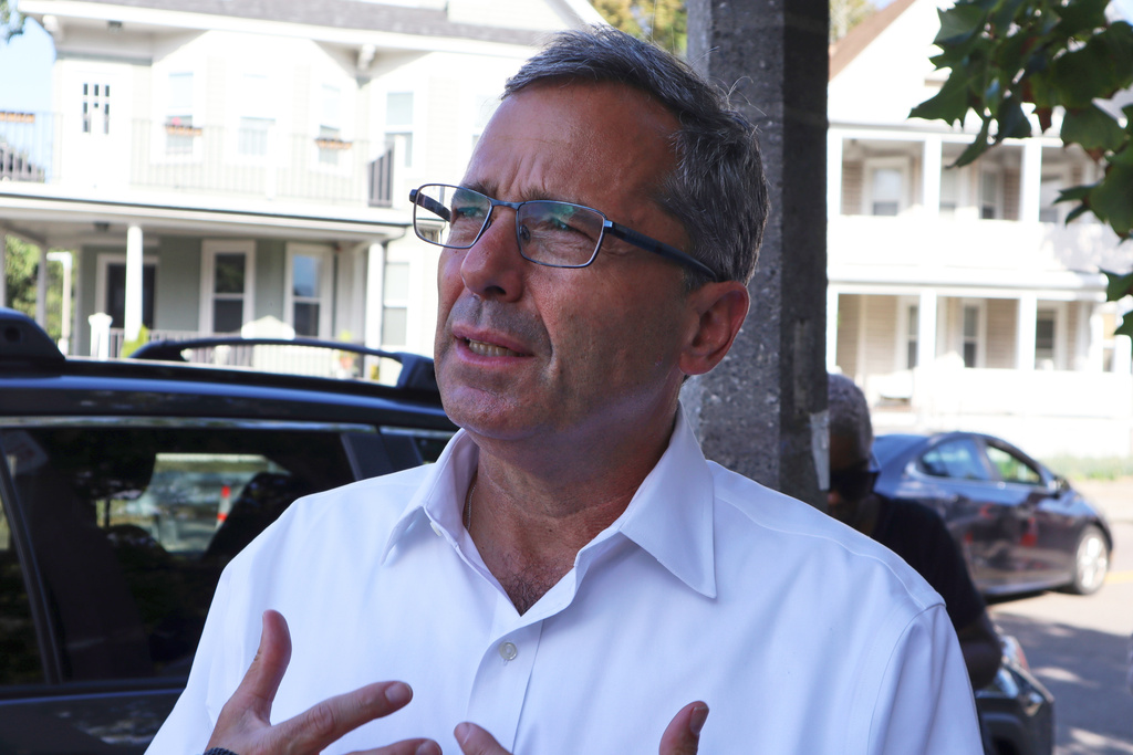 Nonprofit leader and Boston mayoral candidate Josh Kraft, son of Patriots owner Robert Kraft, speaks to a reporter about his campaign while canvassing on Friday, Sept. 5, 2025, in Dorchester, Mass. (AP Photo/Leah Willingham)