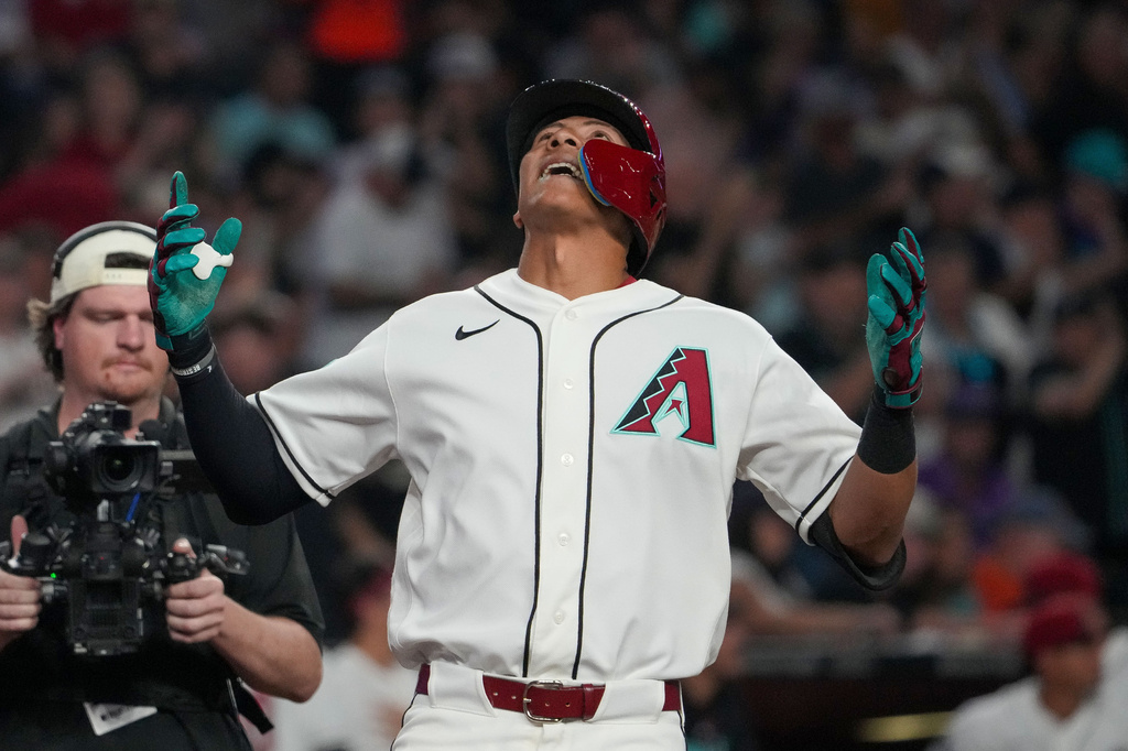 Arizona Diamondbacks' Jose Fernandez (11) looks skyward after hitting a home run in his first game during the fourth inning of a baseball game against the Detroit Tigers Tuesday, March 31, 2026, in Phoenix. (AP Photo/Darryl Webb)