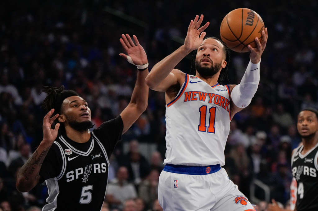 New York Knicks guard Jalen Brunson (11) shoots past San Antonio Spurs guard Stephon Castle during first half of Game 4 of the NBA Finals basketball series, Wednesday, June 10, 2026, in New York. (AP Photo/Ross D. Franklin)