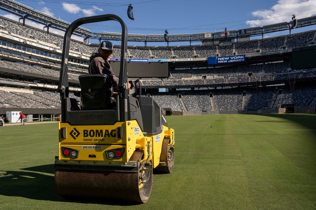 Workers install grass during the pitch installation for FIFA World Cup 2026 at NYNJ Stadium, Thursday, May 7, 2026, in East Rutherford, N.J. (AP Photo/Yuki Iwamura)