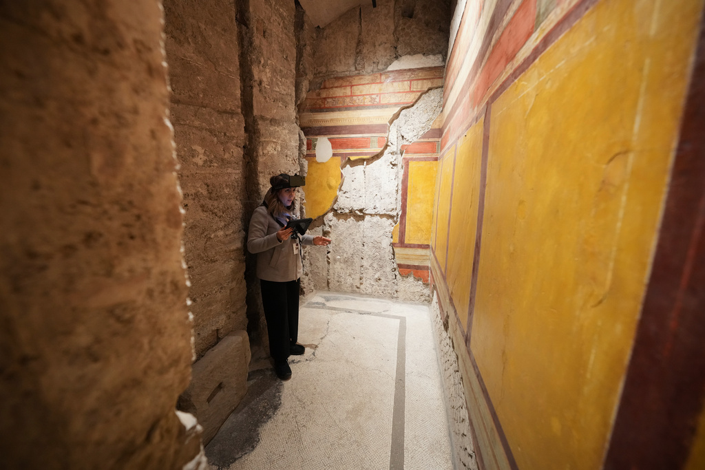 Colosseum Archeological Park guide Valentina uses a head-mounted device to livestream a guided tour for the press of the newly-restored underground House of Griffins, dated between the II and I century B.C., on the Palatine Hill next to the Colosseum, in Rome, Tuesday, Jan. 13, 2026. (AP Photo/Andrew Medichini)
