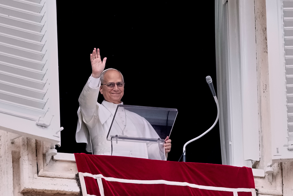 Pope Leo XIV appears at his studio window to deliver the traditional Sunday blessing to faithful and pilgrims gathered in St. Peter's Square at the Vatican for the noon Angelus prayer, Sunday, Feb. 8, 2026. (AP Photo/Gregorio Borgia)
