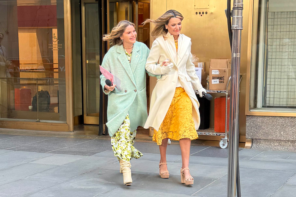 This image released by NBC shows co-host Savannah Guthrie, right, walking with colleague Jenna Bush Hager outside of Rockefeller Center during the "Today" show in New York on Monday, April 6, 2026. (NBC/Today via AP)