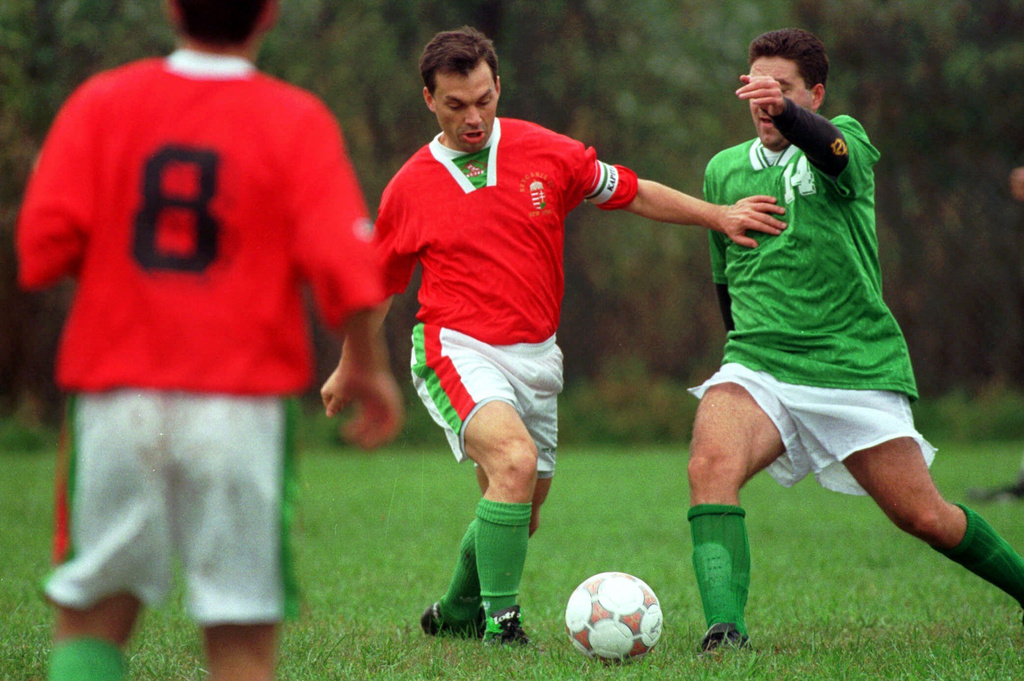 FILE - Hungarian Prime Minister Dr. Viktor Orban, centre, challenges for the ball at the Hungarian Sports Club in Woodbridge, N.J., Saturday, Oct. 10, 1998. (AP Photo/Michael J. Treola)
