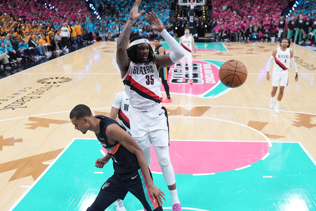Portland Trail Blazers center Robert Williams III (35) scores over San Antonio Spurs forward Victor Wembanyama (1) during the first half in Game 1 of a first-round NBA playoffs basketball series in San Antonio, Sunday, April 19, 2026. (AP Photo/Eric Gay)
