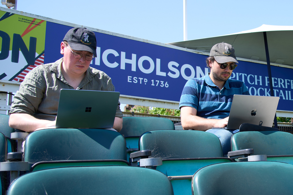 People work from the stands during a Surrey against Sussex County Championship cricket match at the Kia Oval in London, Friday, May 1, 2026. (AP Photo/Tony Hicks)