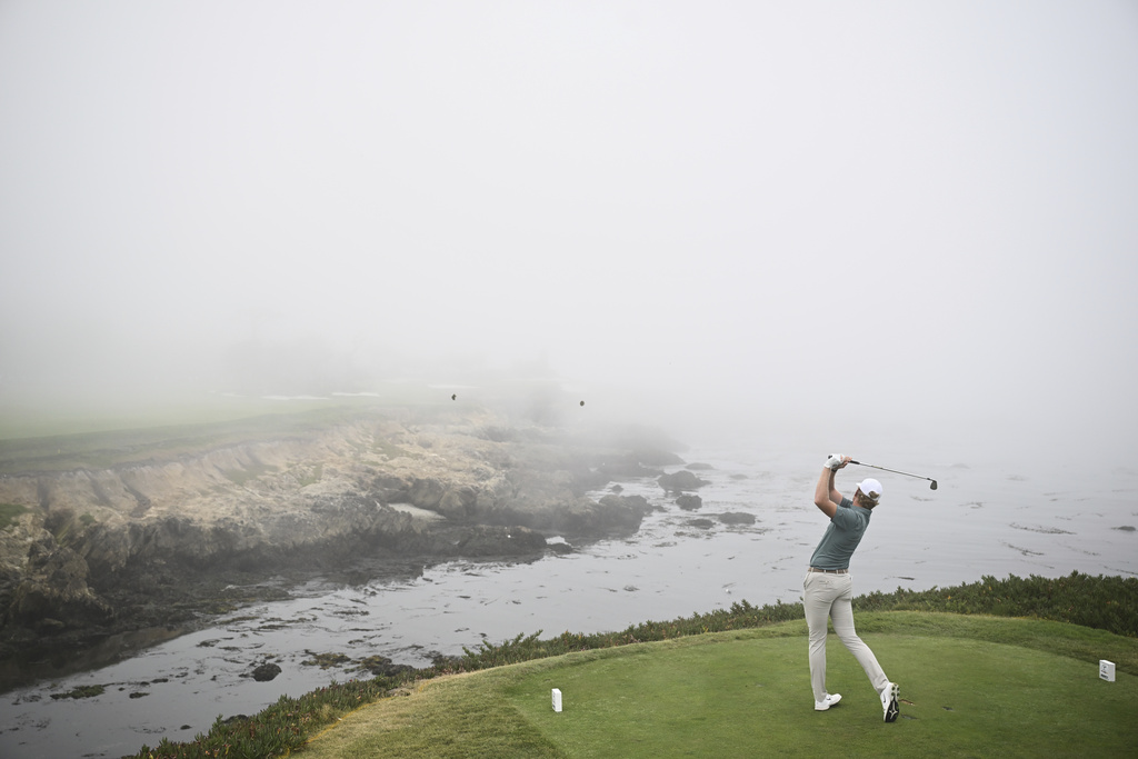 The Great Britain and Ireland team's Luke Poulter hits from the 17th tee during Walker Cup golf matches against the USA team at Cypress Point Club on Sunday, Sept. 7, 2025, in Pebble Beach, Calif. (AP Photo/Thien-An Truong )