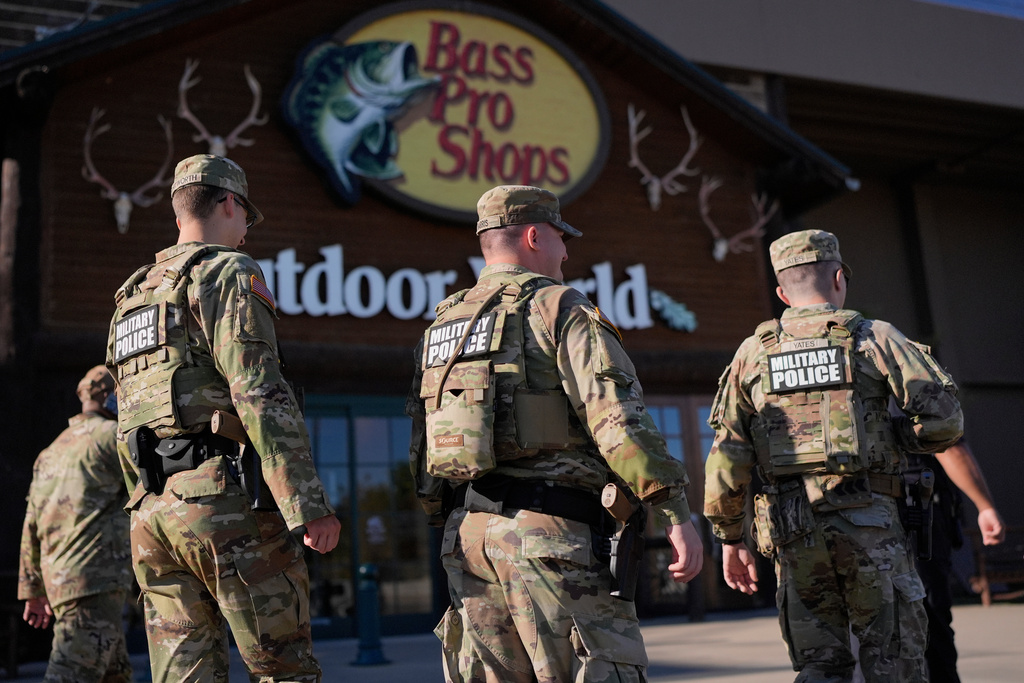 Members of National Guard patrol outside a Bass Pro Shops, Friday, Oct. 10, 2025, in Memphis, Tenn. (AP Photo/George Walker IV)