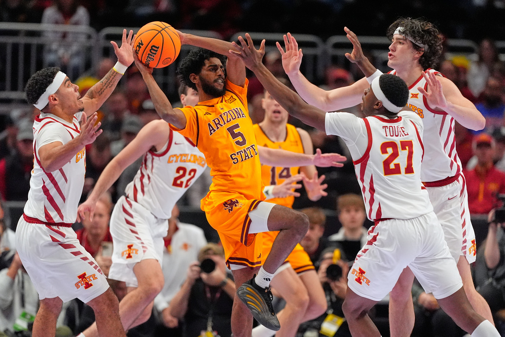 Arizona State's Maurice Odum (5) tries to pass as Iowa State's Tamin Lipsey, left, Killyan Toure (27) and Blake Buchanan, right, defend during the second half of an NCAA college basketball game in the second round of the Big 12 Conference tournament Wednesday, March 11, 2026, in Kansas City, Mo. (AP Photo/Charlie Riedel)