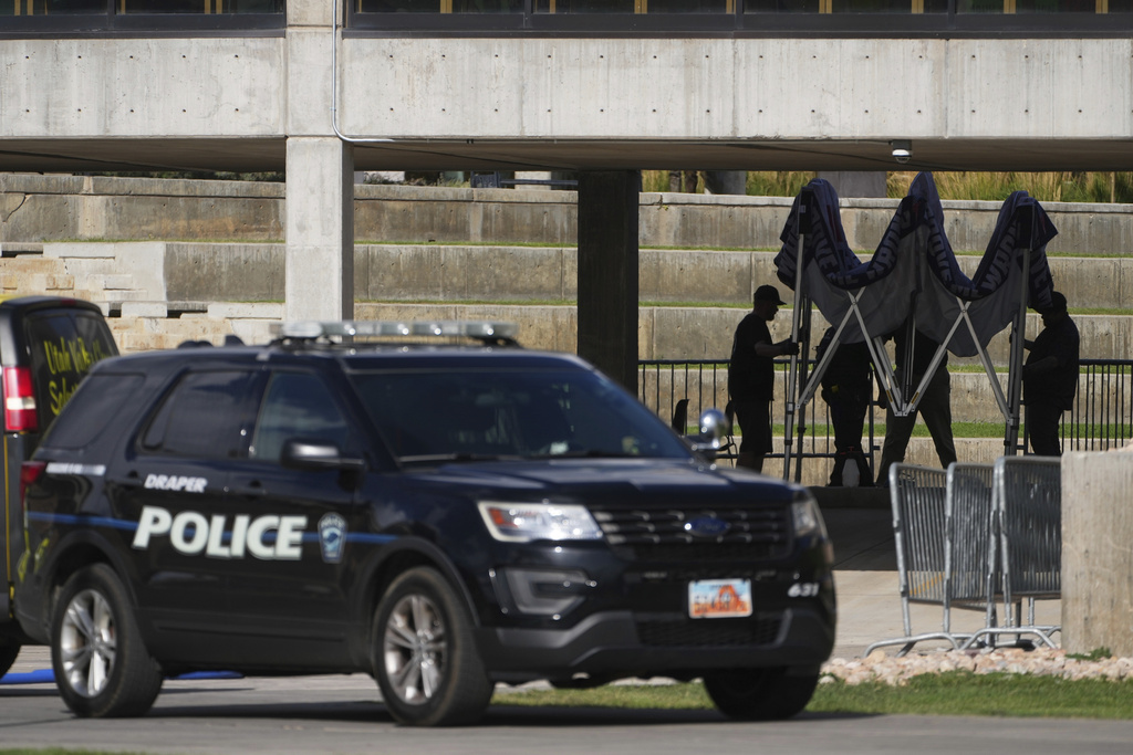 FILE - People clean up the scene at Utah Valley University on Sept. 12, 2025, in Orem, Utah, after Charlie Kirk was shot and killed. (AP Photo/Lindsey Wasson, File)