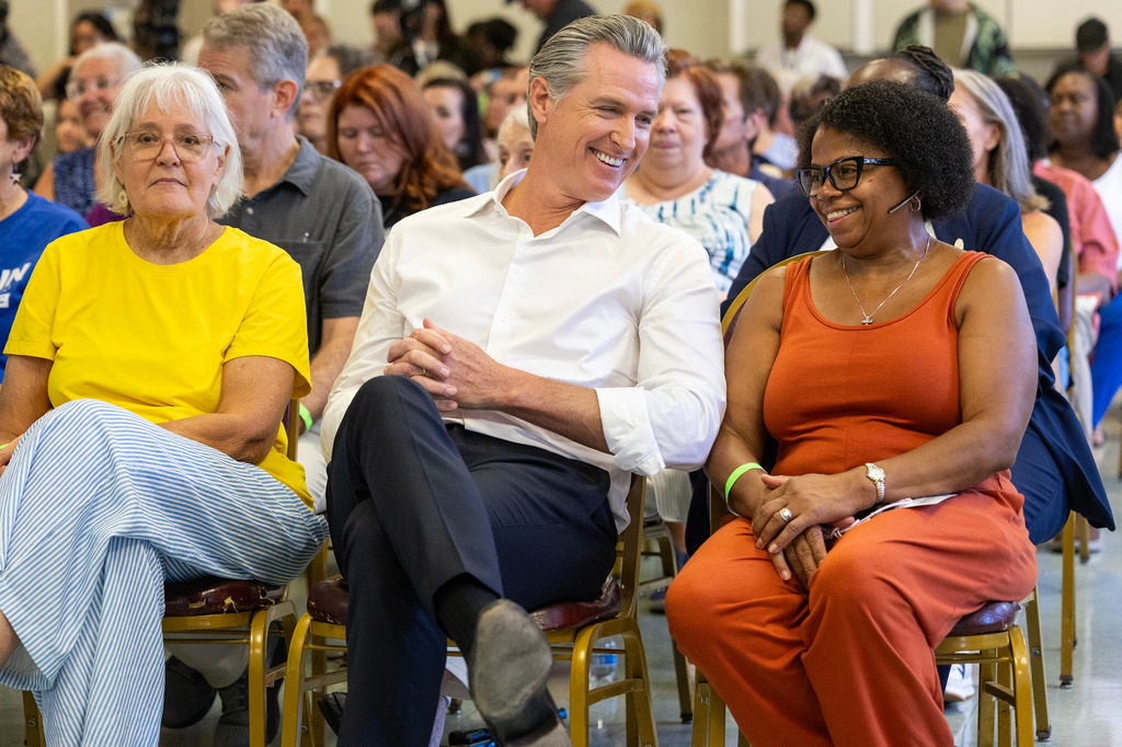 California Gov. Gavin Newsom shares a laugh with Dianne Kittrell, right, during a campaign event at the Brookland-Lakeview Empowerment Center, Friday, Sept. 4, 2026, in West Columbia, S.C. (AP Photo/Mic Smith)