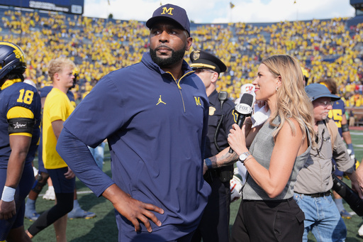 Michigan head coach Sherrone Moore gives a news interview after the team's win in an NCAA college football game against Wisconsin, Saturday, Oct. 4, 2025, in Ann Arbor, Mich. (AP Photo/Ryan Sun) Michigan head coach Sherrone Moore gives a news interview after the team's win in an NCAA college football game against Wisconsin, Saturday, Oct. 4, 2025, in Ann Arbor, Mich. (AP Photo/Ryan Sun)