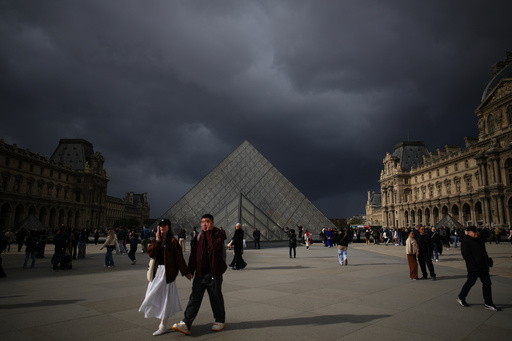 People tour the courtyard of Le Louvre museum Monday, Oct. 27, 2025 in Paris. (AP Photo/Christophe Ena) People tour the courtyard of Le Louvre museum Monday, Oct. 27, 2025 in Paris. (AP Photo/Christophe Ena)