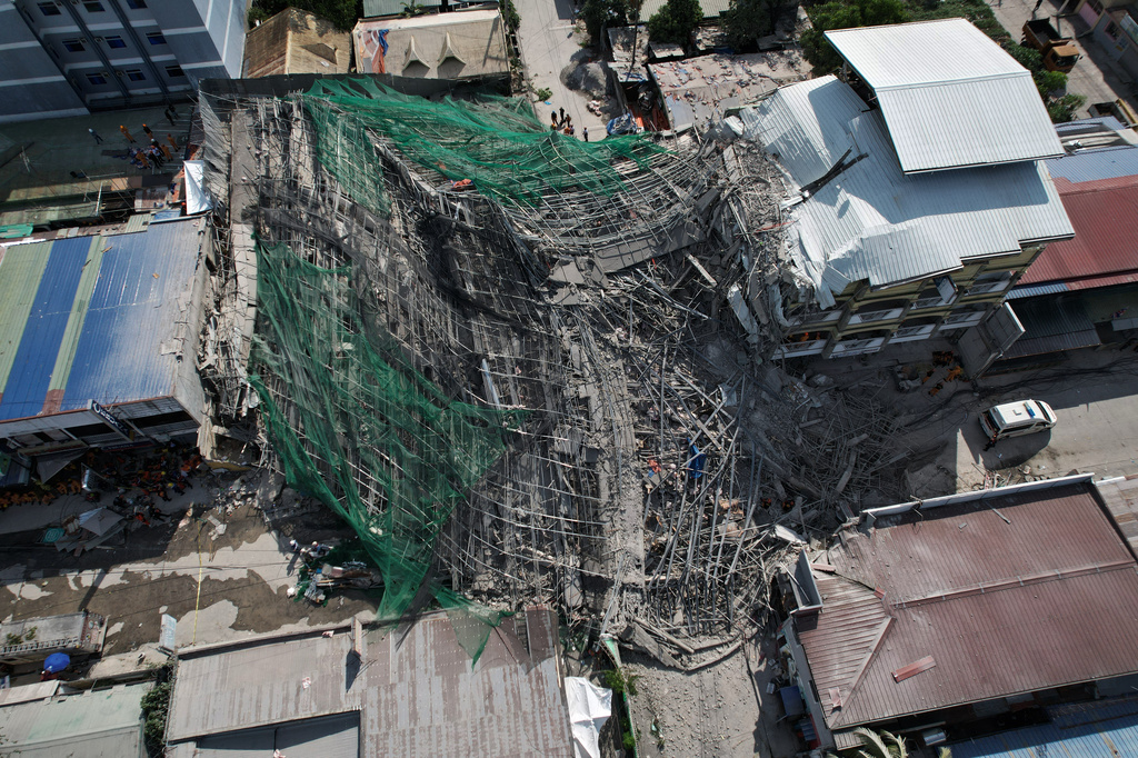 A collapsed building where multiple people are believed to be trapped in Angeles city in Pampanga province, north of Manila, Philippines Sunday, May 24, 2026. (AP Photo/Aaron Favila)
