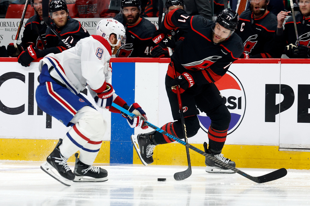 Carolina Hurricanes' Taylor Hall (71) controls the puck with Montréal Canadiens' Mike Matheson (8) nearby during the second period in Game 1 of the Eastern Conference finals NHL hockey Stanley Cup playoffs series in Raleigh, N.C., Thursday, May 21, 2026. (AP Photo/Karl DeBlaker)