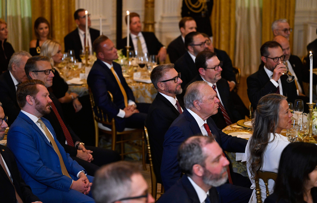 Guests listens as President Donald Trump addresses a dinner for donors who have contributed to build the new ballroom at the White House, Wednesday, Oct. 15, 2025, in Washington. (AP Photo/John McDonnell)