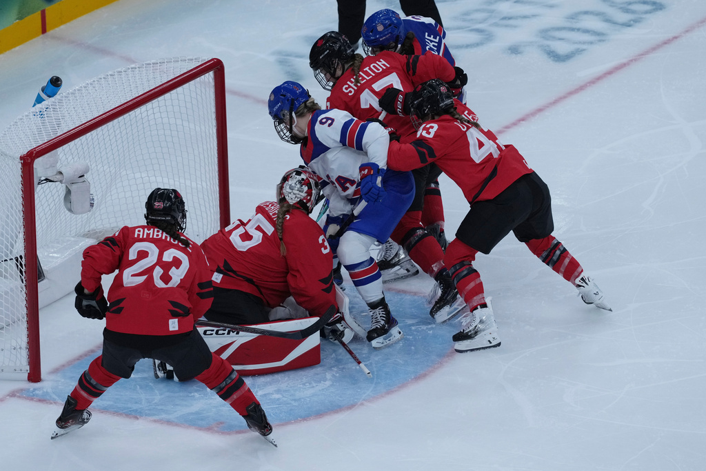 United States' Kirsten Simms scores her side's third goal during a preliminary round match of women's ice hockey between USA and Canada at the 2026 Winter Olympics, in Milan, Italy, Tuesday, Feb. 10, 2026. (AP Photo/Antonio Calanni)