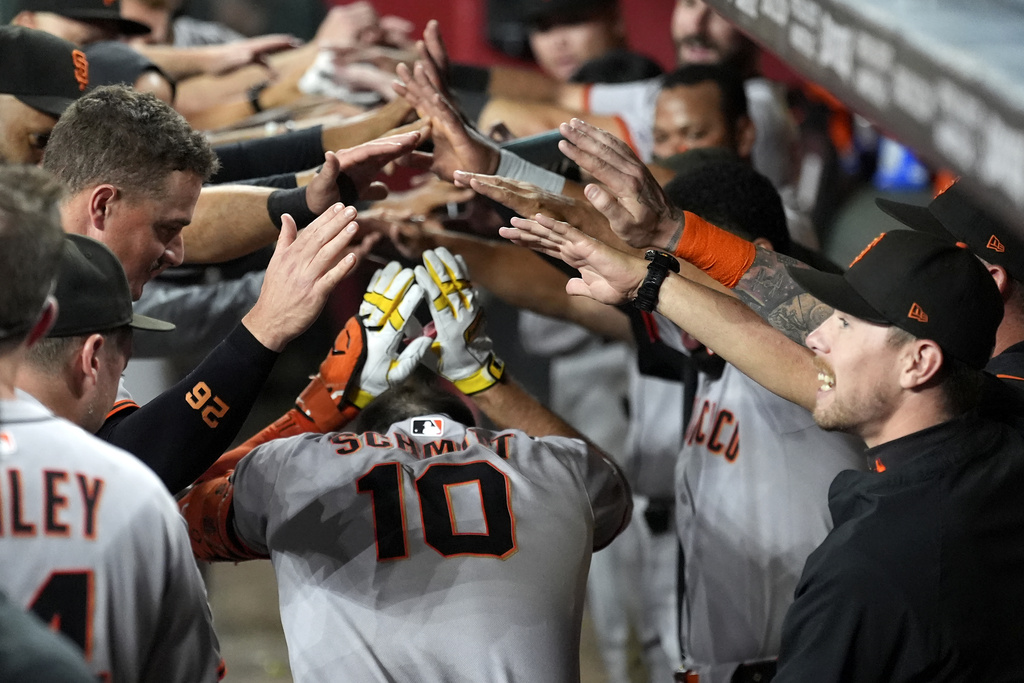 San Francisco Giants' Casey Schmitt celebrates his home run against the Arizona Diamondbacks with teammates and coaches in the team dugout during the third inning of a baseball game Monday, Sept. 15, 2025, in Phoenix. (AP Photo/Ross D. Franklin)