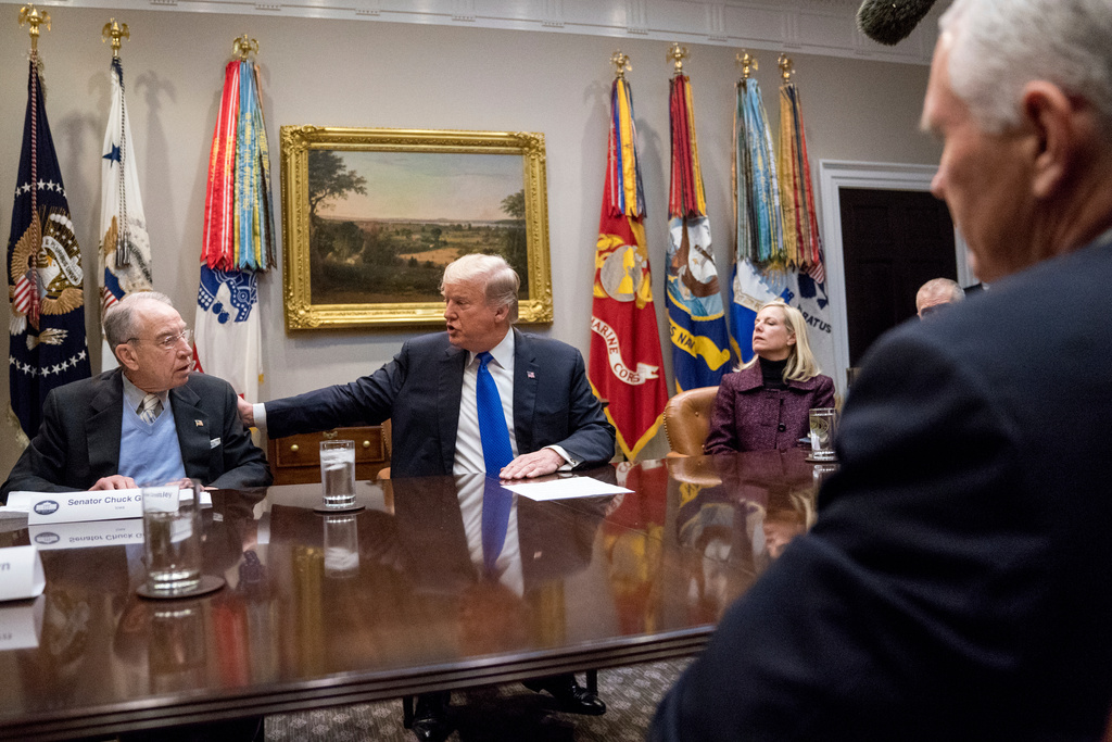 FILE - President Donald Trump, accompanied by Sen. Chuck Grassley, R-Iowa, left, and Secretary of Homeland Security Kirstjen Nielsen, right, speaks at a meeting on immigration with Republican Senators in the Roosevelt Room at the White House, Thursday, Jan. 4, 2018, in Washington. (AP Photo/Andrew Harnik, File)