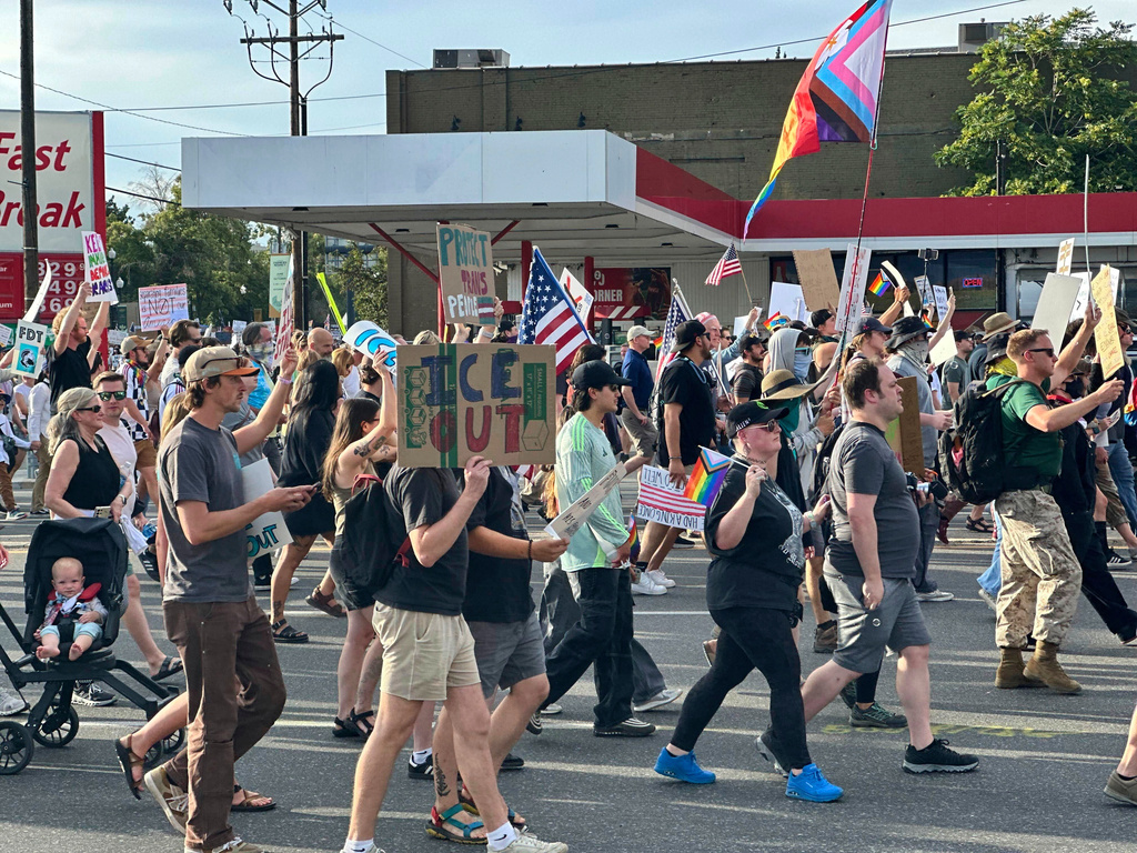 FILE - Demonstrators carry signs and chant while marching during a "No Kings" protest, June 14, 2025, in Salt Lake City. (AP Photo/Amanda Barrett, file)