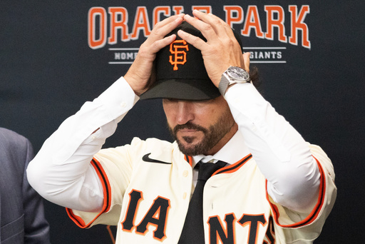 Tony Vitello dons a baseball cap as he is introduced as the new manager of the San Francisco Giants baseball team, Thursday, Oct. 30, 2025, in San Francisco. (AP Photo/Benjamin Fanjoy) Tony Vitello dons a baseball cap as he is introduced as the new manager of the San Francisco Giants baseball team, Thursday, Oct. 30, 2025, in San Francisco. (AP Photo/Benjamin Fanjoy)