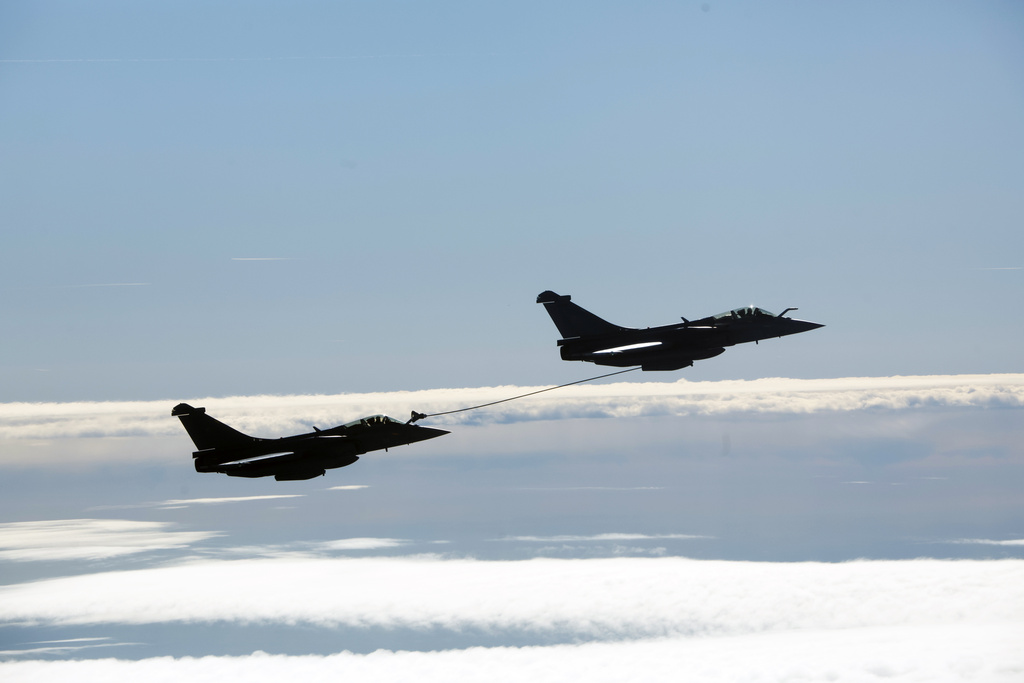 A refueling operation between two Rafale aircraft takes place moments before the arrival of French President Emmanuel Macron at the nuclear submarine navy base of Ile Longue in Crozon, France, Monday March 2, 2026.(Yoan Valat/Pool Photo via AP)
