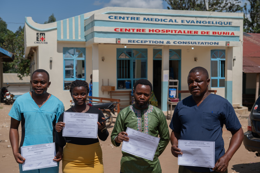 Healthcare workers who have recovered from Ebola pose for a photo in Bunia, Congo, Sunday, May 31, 2026. (AP Photo/Moses Sawasawa)
