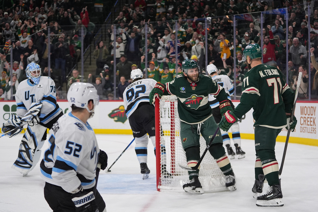 Minnesota Wild right wing Ryan Hartman, middle right, celebrates with left wing Nick Foligno (71) after scoring a goal during the third period of an NHL hockey game, Tuesday, March 10, 2026, in St. Paul, Minn. (AP Photo/Abbie Parr)