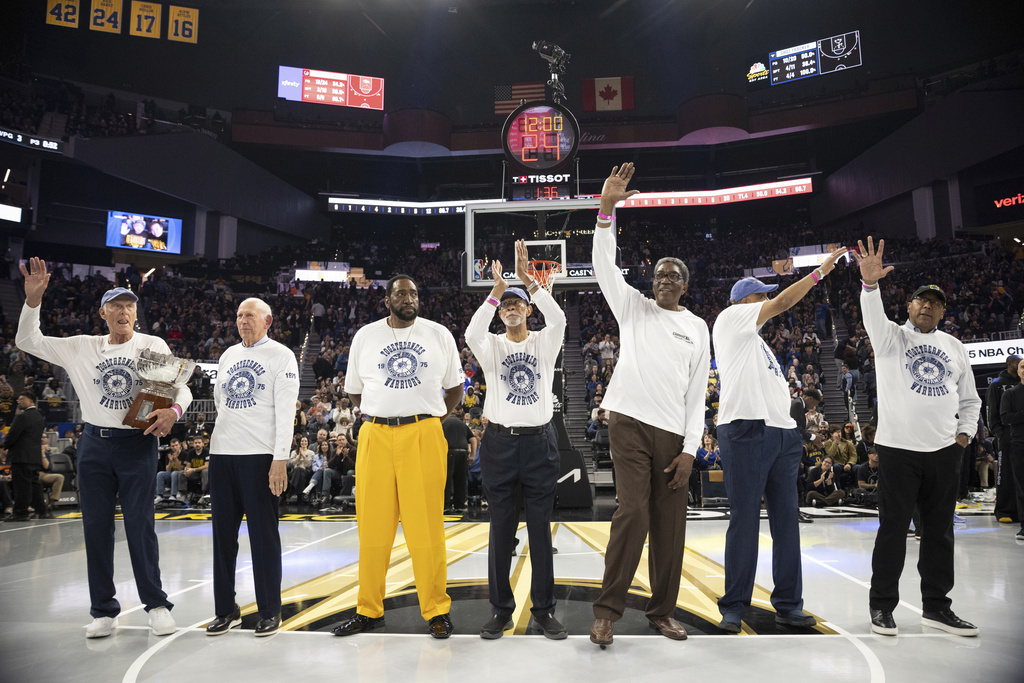 Members of the 1974-1975 Golden State Warriors NBA Championship team wave during a ceremony at the first half of the NBA Cup basketball game against the Portland Trail Blazers in San Francisco, Friday, Nov. 21, 2025. (Stephen Lam/San Francisco Chronicle via AP)