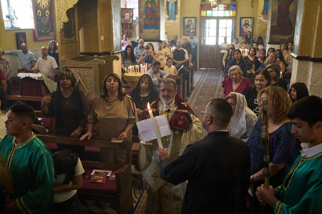 Greek Orthodox parish priest David Khoury attends morning Mass at St. George church in the West Bank village of Taybeh, Sept. 28, 2025. (AP Photo/Leo Correa)