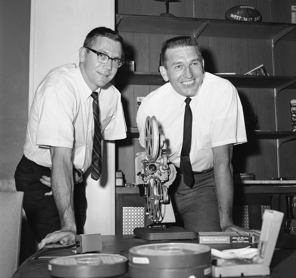 FILE - Baltimore Colts quarterback Johnny Unitas and veteran split end Raymond Berry, left, review films of previous Colt games in Baltimore on Oct. 25, 1967. (AP Photo/William Smith, file)