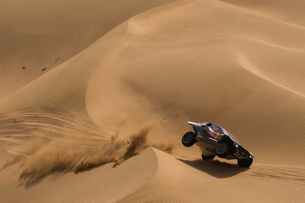 Driver Carlos Sainz and co-driver Lucas Cruz compete during the twelfth stage of the Dakar Rally between Al Henakiyah and Yanbu, Saudi Arabia, Friday, Jan.16, 2026. (AP Photo/Thibault Camus)