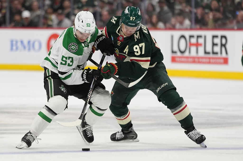 Dallas Stars center Wyatt Johnston (53) and Minnesota Wild left wing Kirill Kaprizov (97) battle for the puck during the second period of Game 3 in the first round of the NHL Stanley Cup hockey playoffs Wednesday, April 22, 2026, in St. Paul, Minn. (AP Photo/Abbie Parr)