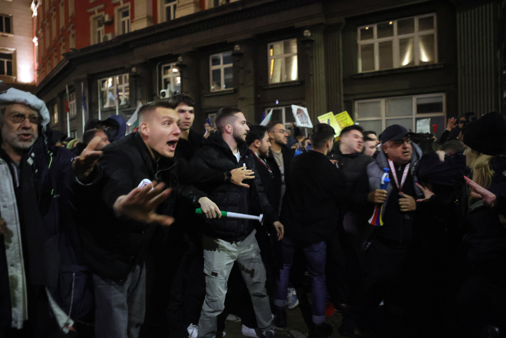 Protesters shout at policemen as thousands took to the streets of Bulgaria's capital, Sofia, to denounce steep tax hikes in next year's draft budget before being finally voted on in parliament, Wednesday, Nov 26, 2025. (AP Photo/Valentina Petrova)